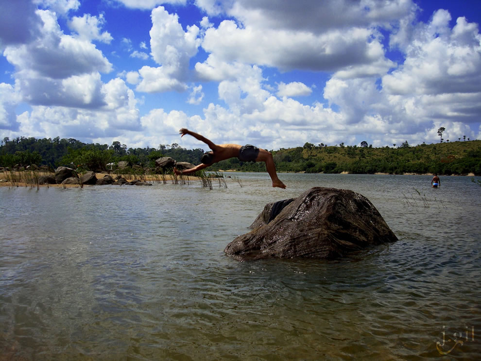 Rock jumping on a hot day as the rivers of Amazon suffer flooding for 4 or 5 months of the year